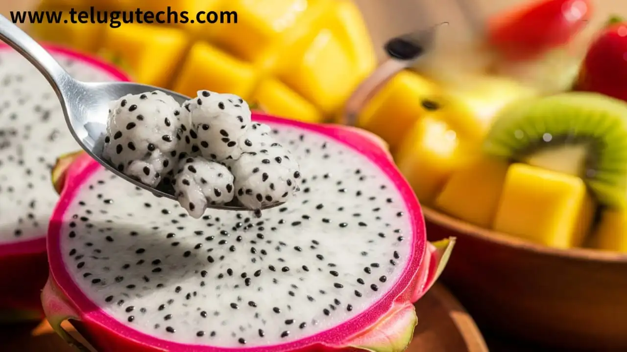 Dragon Fruit - Red dragon fruit cut in half with spoon, fresh fruit salad, healthy eating concept.
